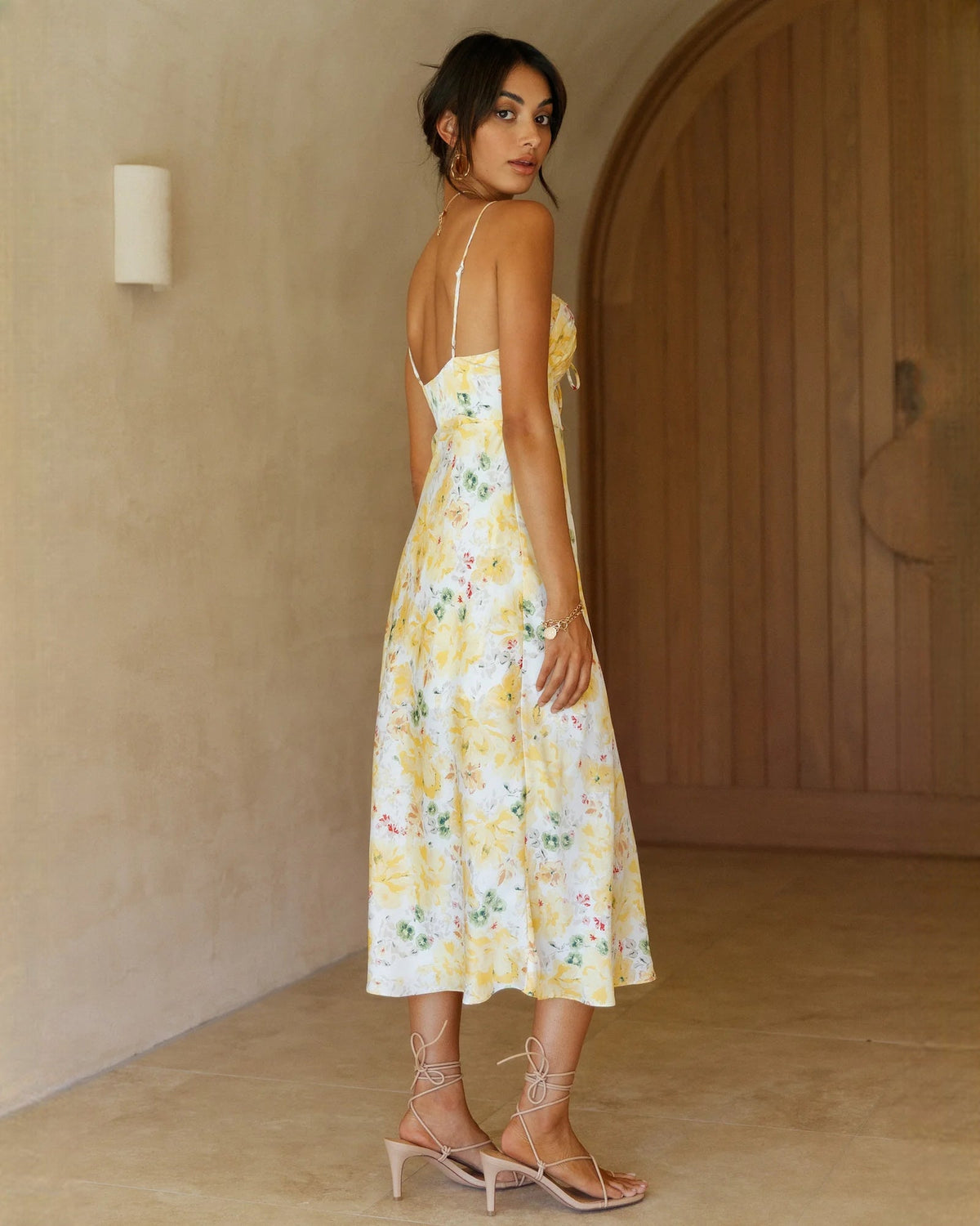 Yellow floral chiffon A-line midi dress from back with narrow straps