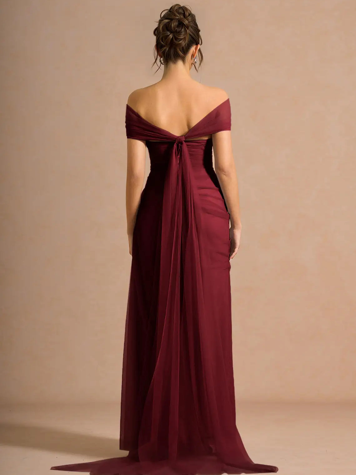 Off-shoulder formal dress in burgundy with open back and draped waist detail