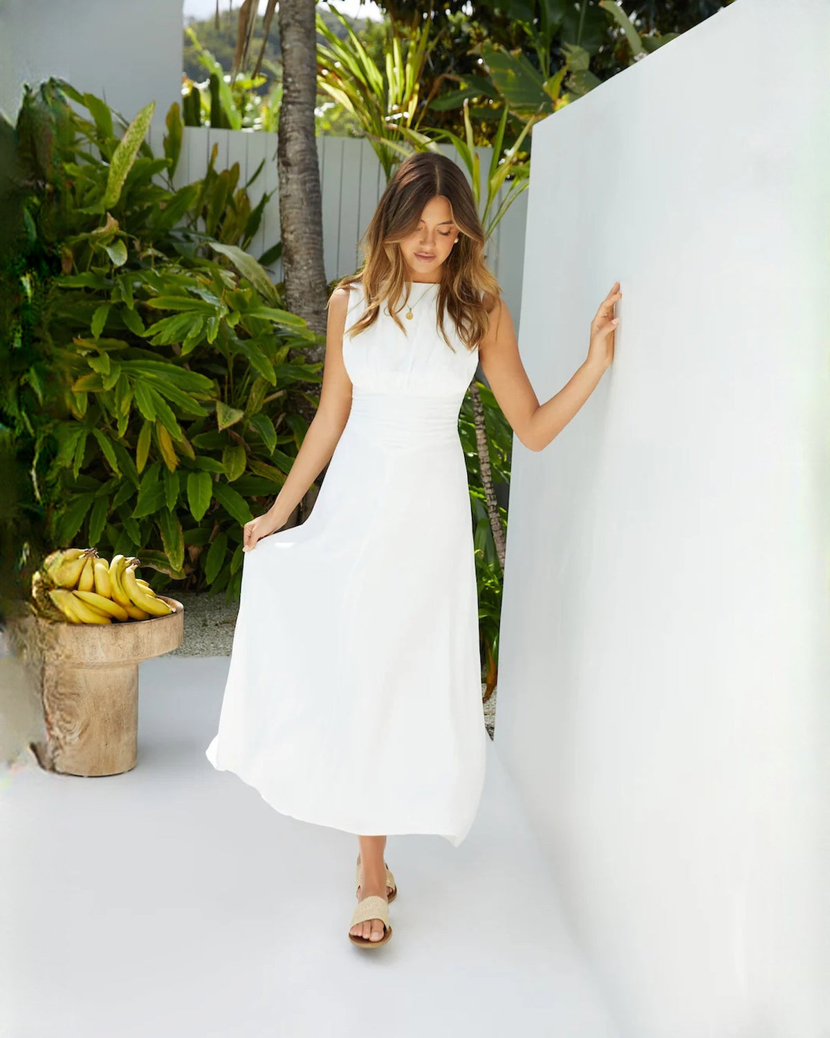 White sleeveless satin A-line maxi dress with flared A-line skirt