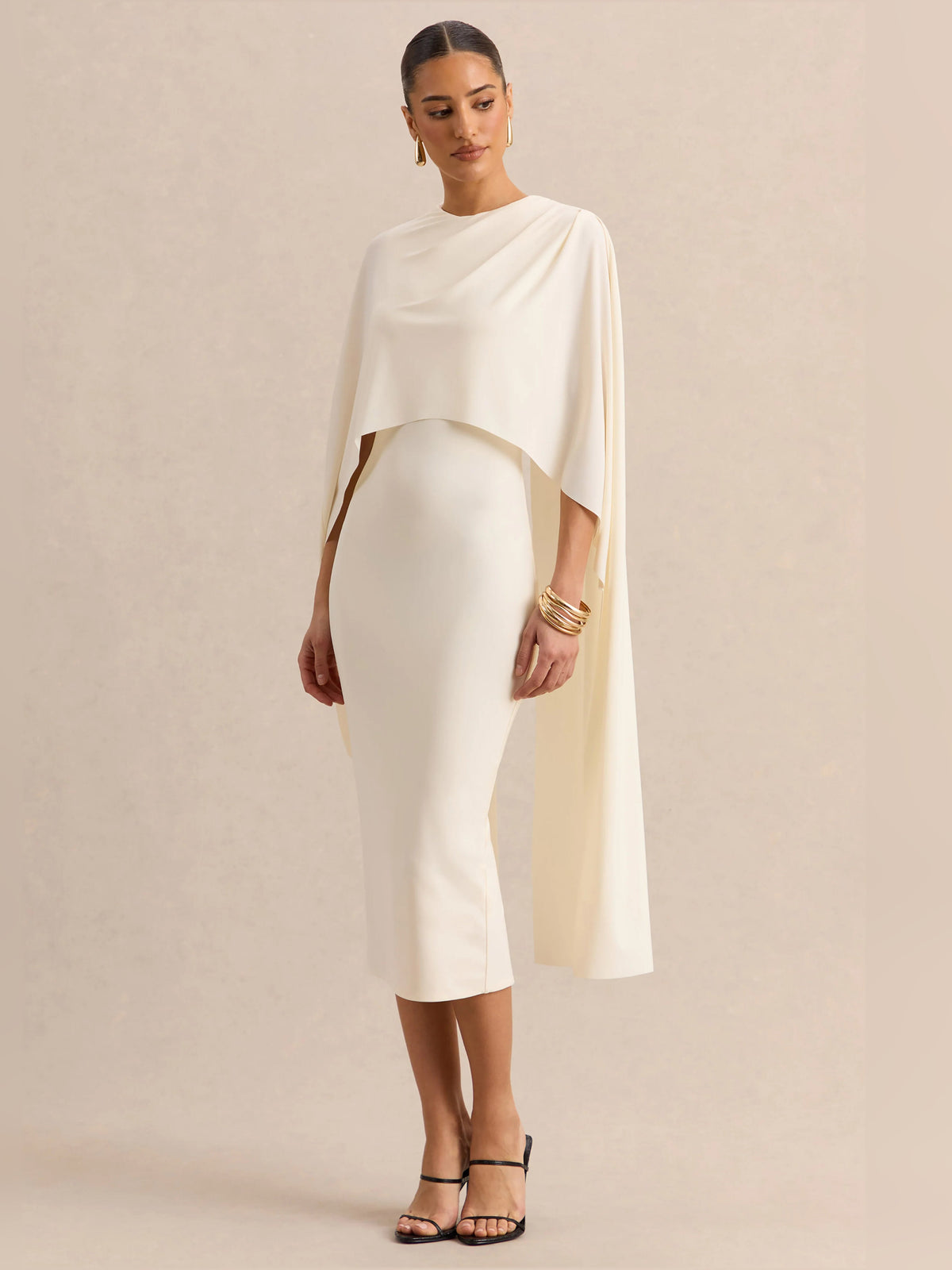 Cream midi formal dress full length view with round neck, pencil fit, and cape overlay