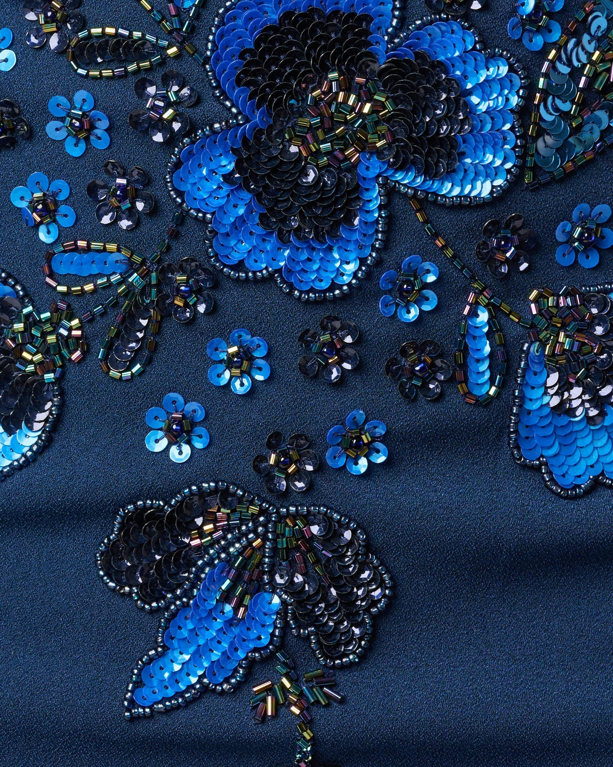 Blue and black floral sequin detailing on light navy fabric