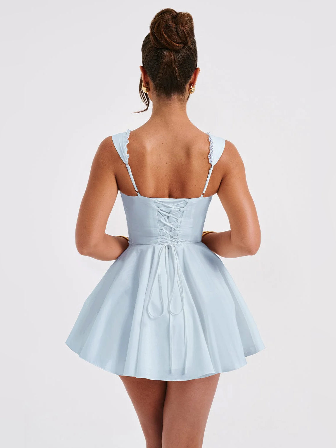 Back view of light blue mini dress with lace-trimmed straps and gathered corset waist