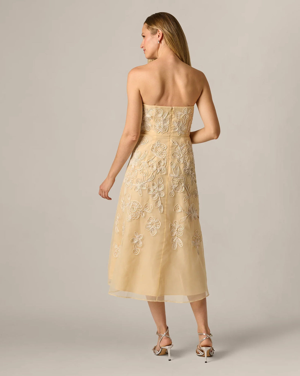 Pale yellow A-line midi dress with strapless front and open-back design