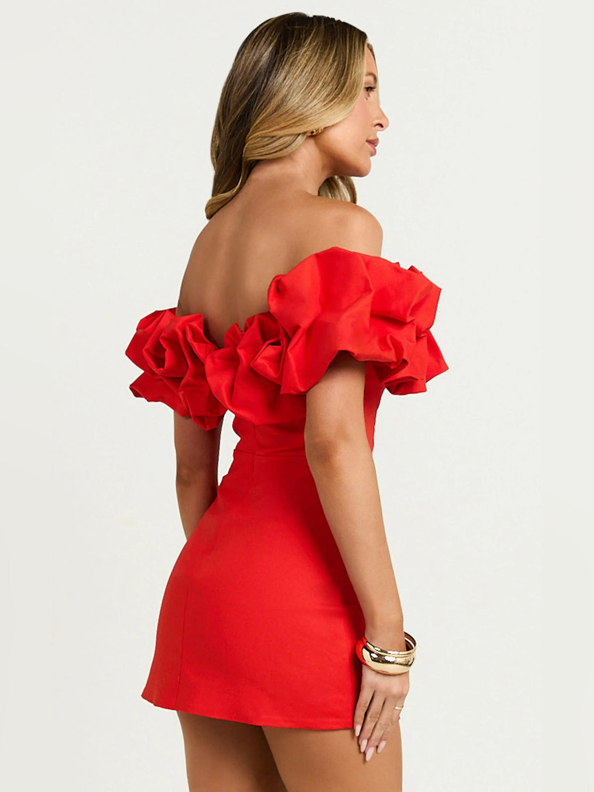 Red off-shoulder mini dress, side view with layered ruffle shoulders, fitted