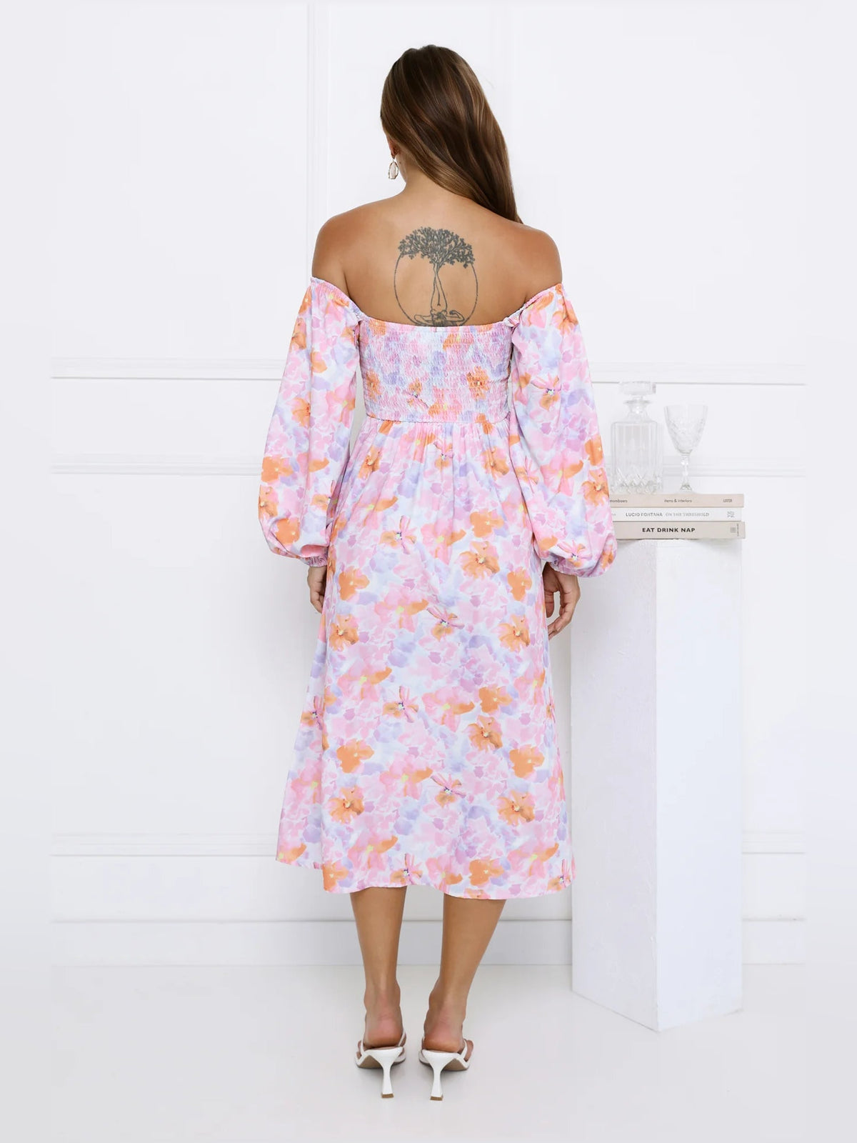 Back view of pastel floral off-shoulder midi dress with puff sleeves and midi length.