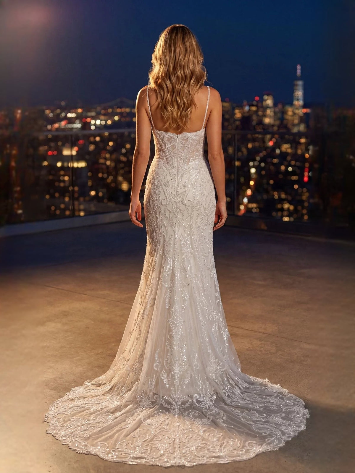 Ivory mermaid wedding dress shown from back with thin straps and lace tulle skirt