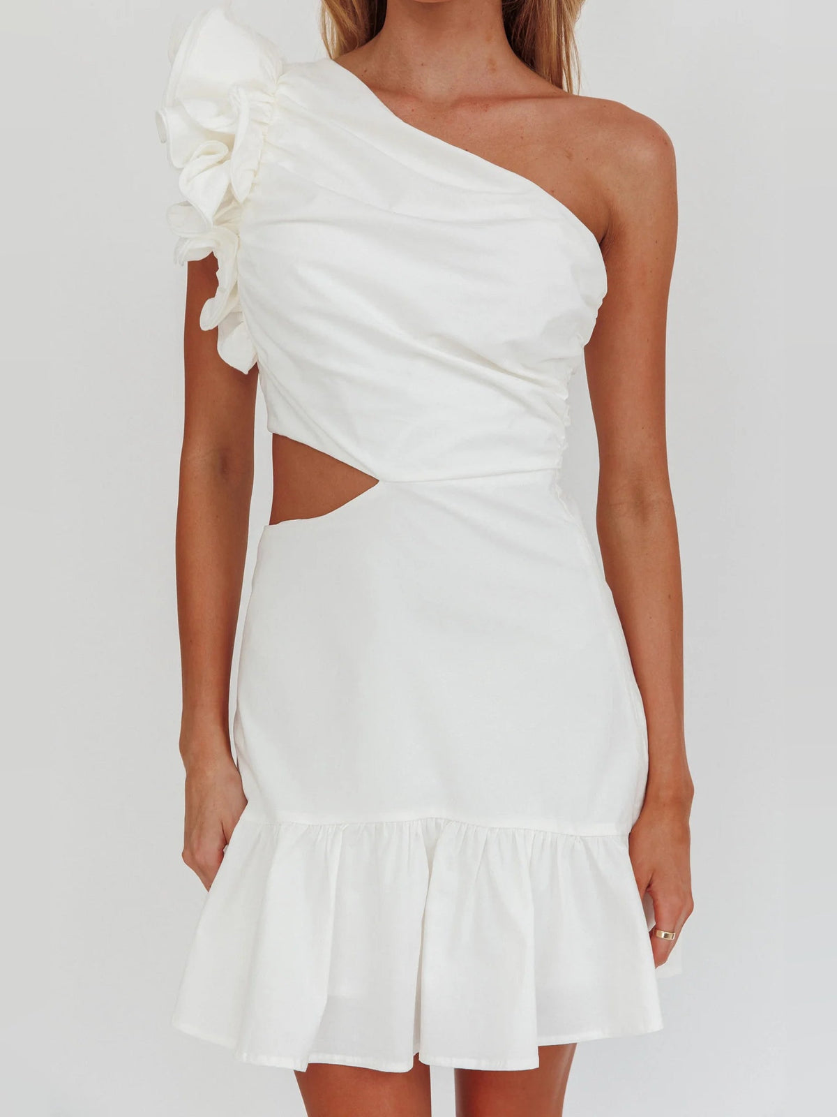 White one-shoulder mini dress with waist cut-out and tiered hem, ruched bodice