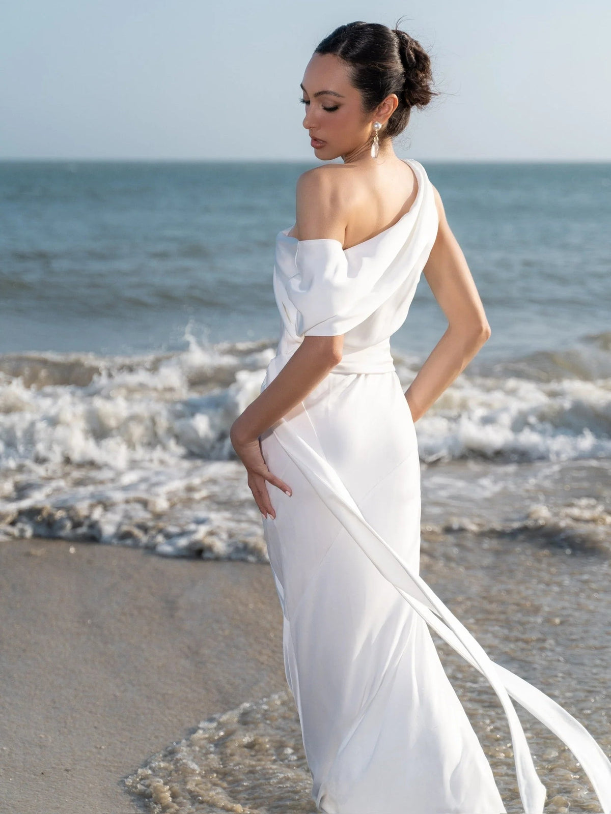 White satin halter-neck sheath midi dress with cascading side drape