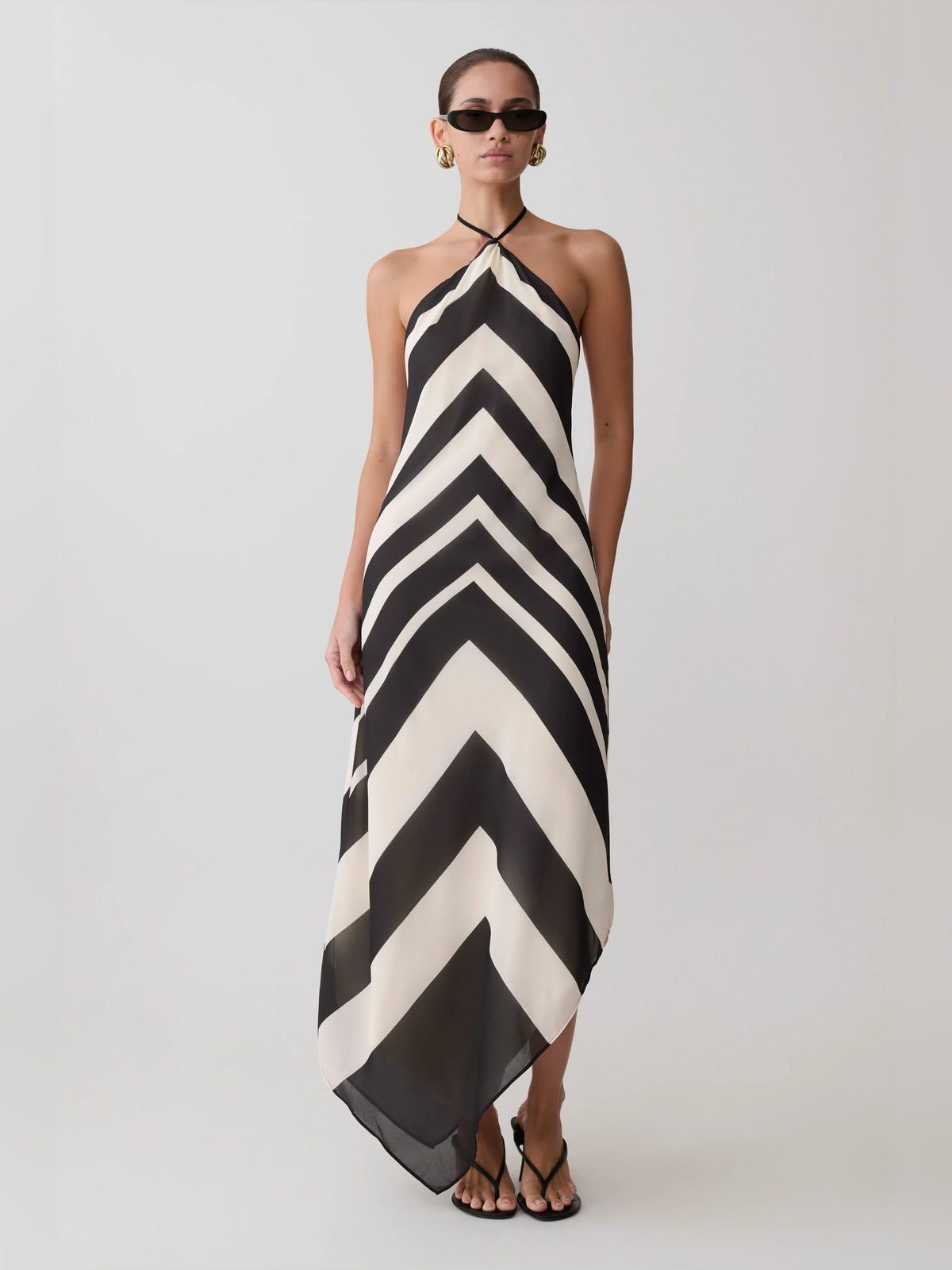 Satin halter midi formal dress with black-and-white chevron zigzag pattern and halter straps.
