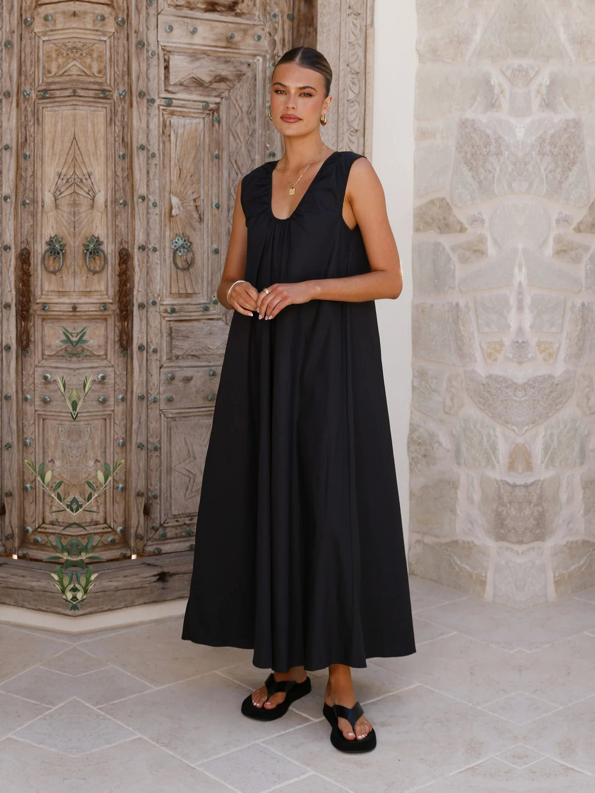 Black a-line maxi formal dress with halter neckline, alternate view showing the hem
