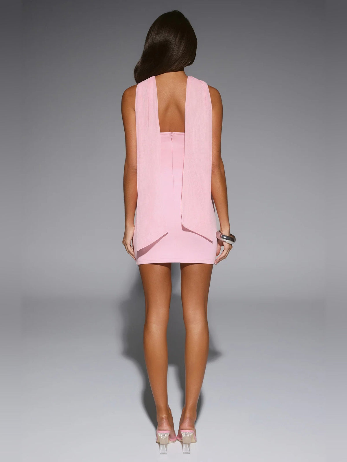 Pink strapless mini dress, back view with open back and draped overlay