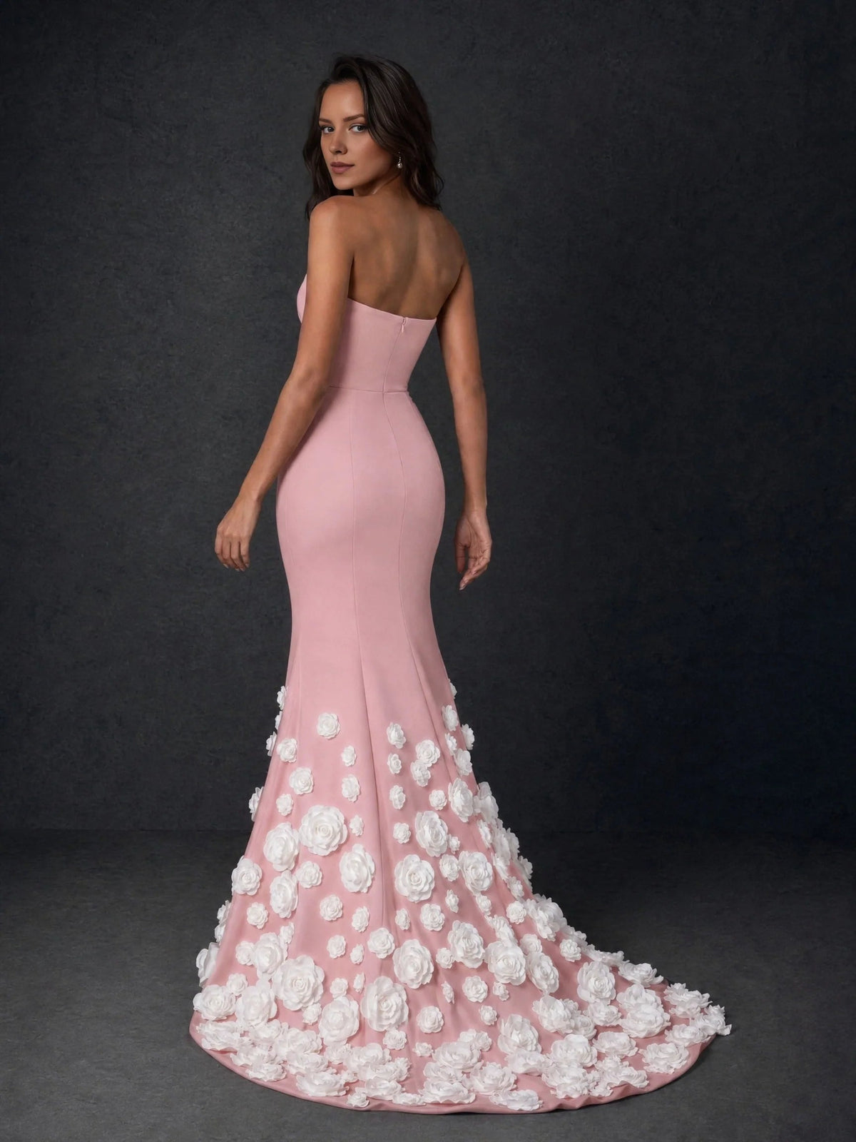 Blush pink strapless formal gown, back view, with white rose appliques on flared skirt