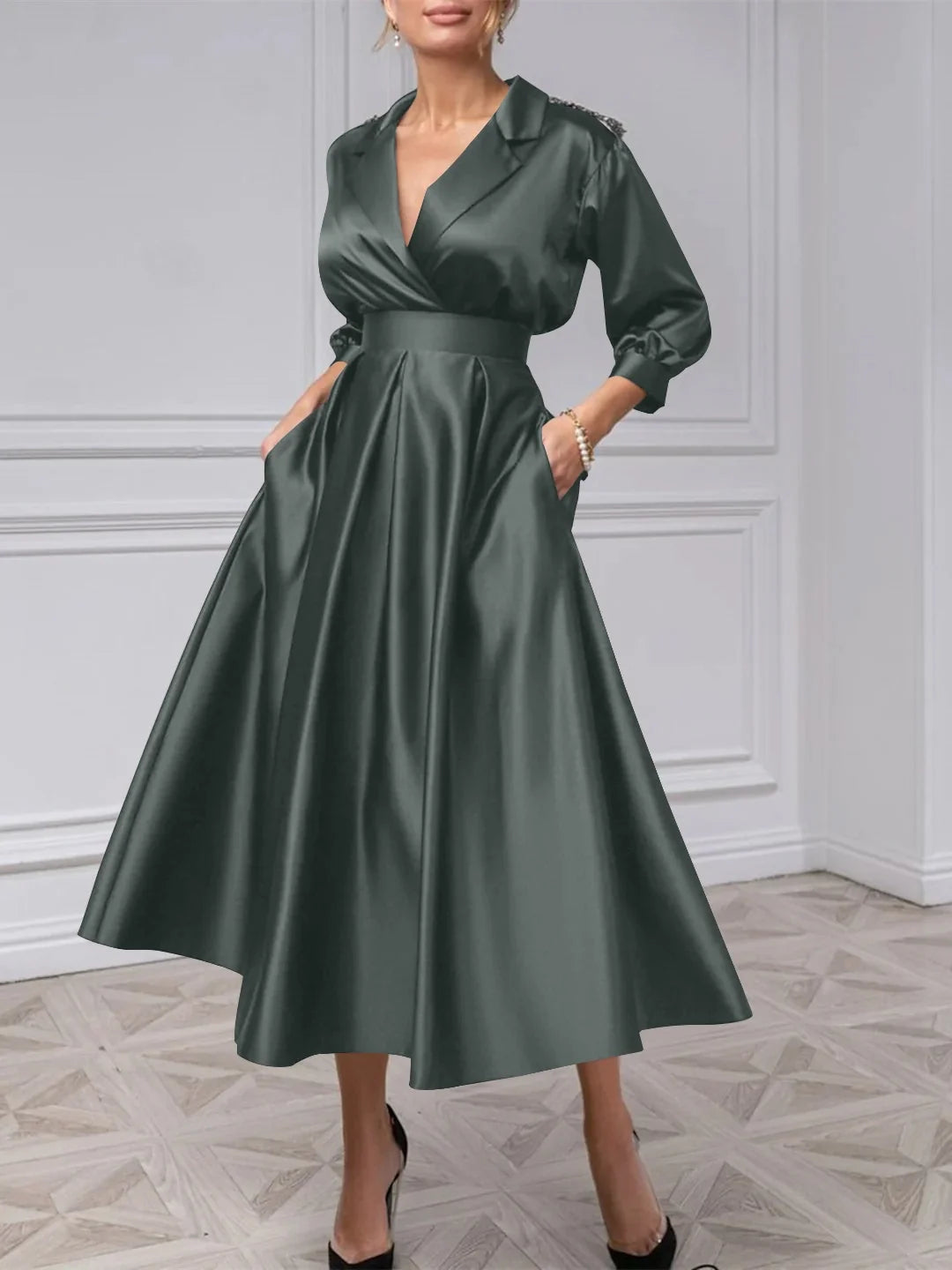 Forest green satin midi dress with V-neck, long puff sleeves, and A-line pleated skirt