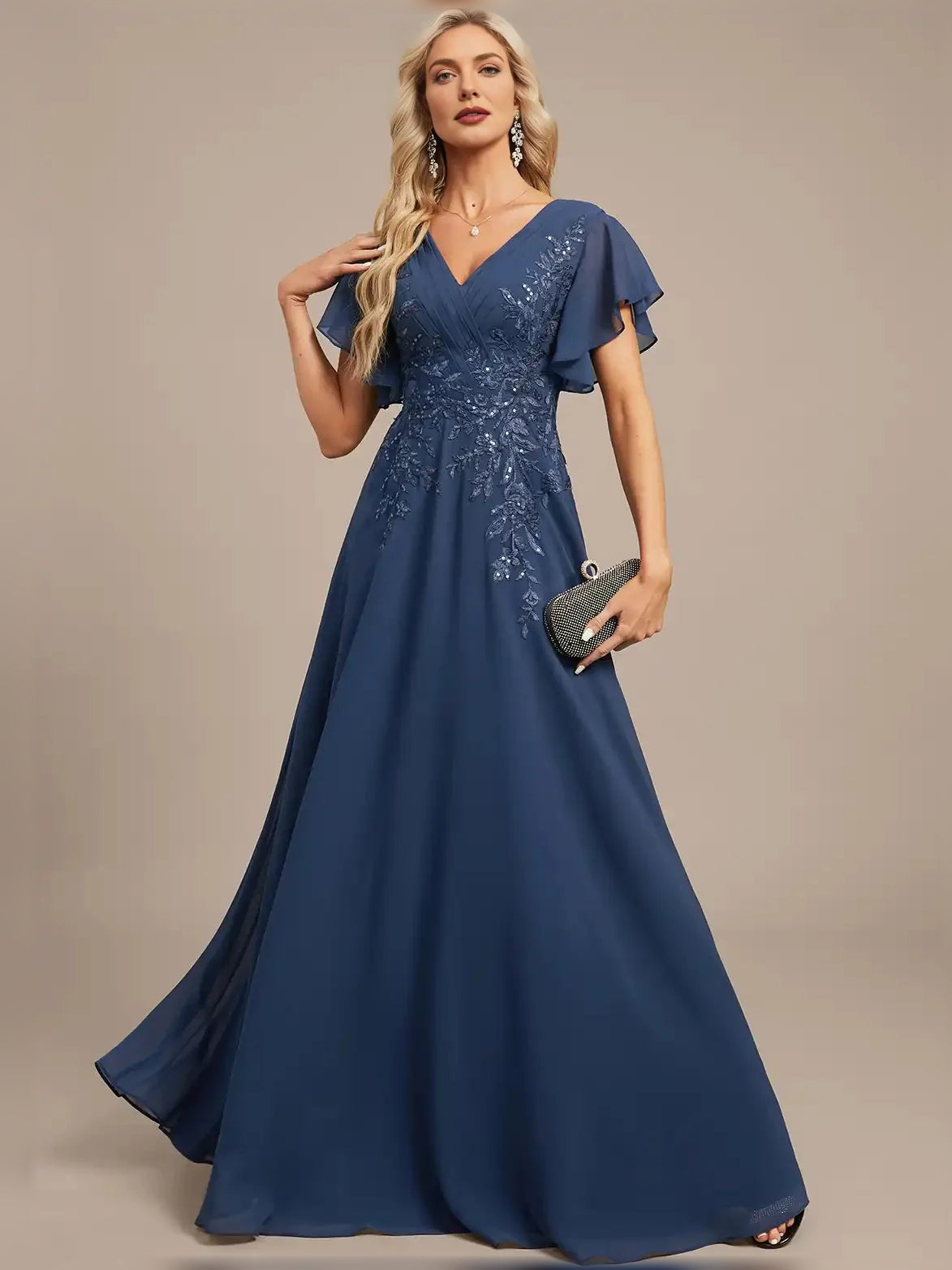 Blue V-neck A-line maxi dress, front view, with floral embroidery and pleated skirt.