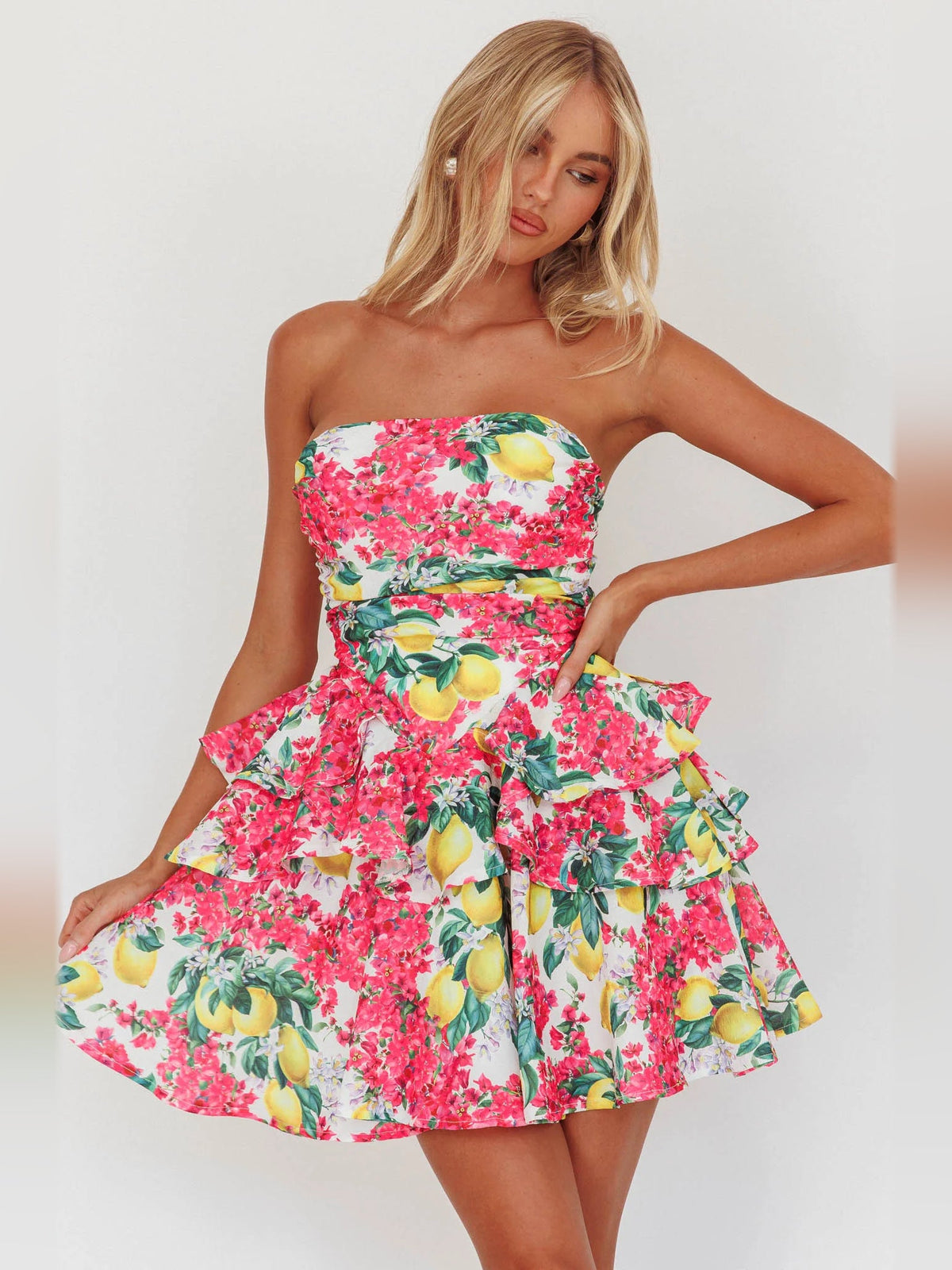 Layered mini dress in pink lemon floral print with strapless bodice and ruffled tiers