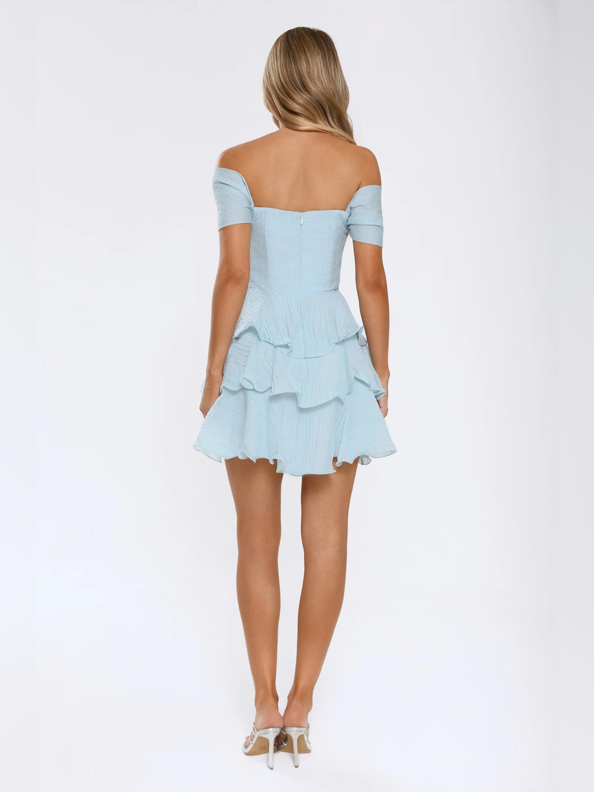 Light blue off-shoulder mini dress from the back with tiered ruffle skirt