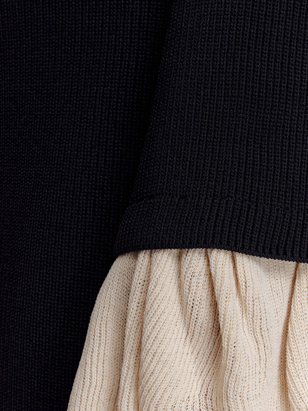Amirose black knit dress fabric detail with cream ribbed ruffle cuff