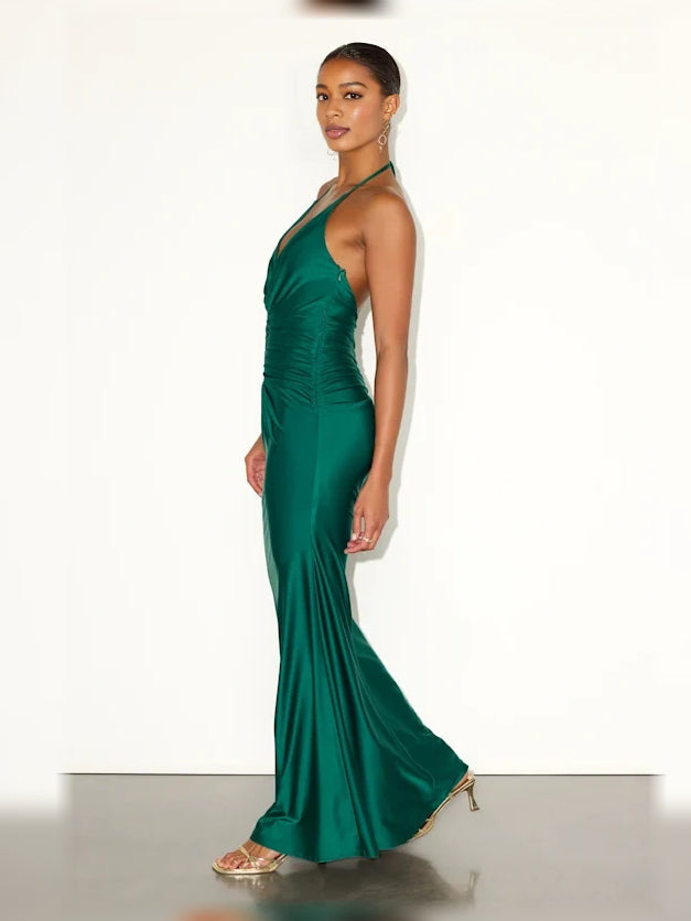 Emerald green halter neck formal dress with ruched waist and floor-length mermaid hem