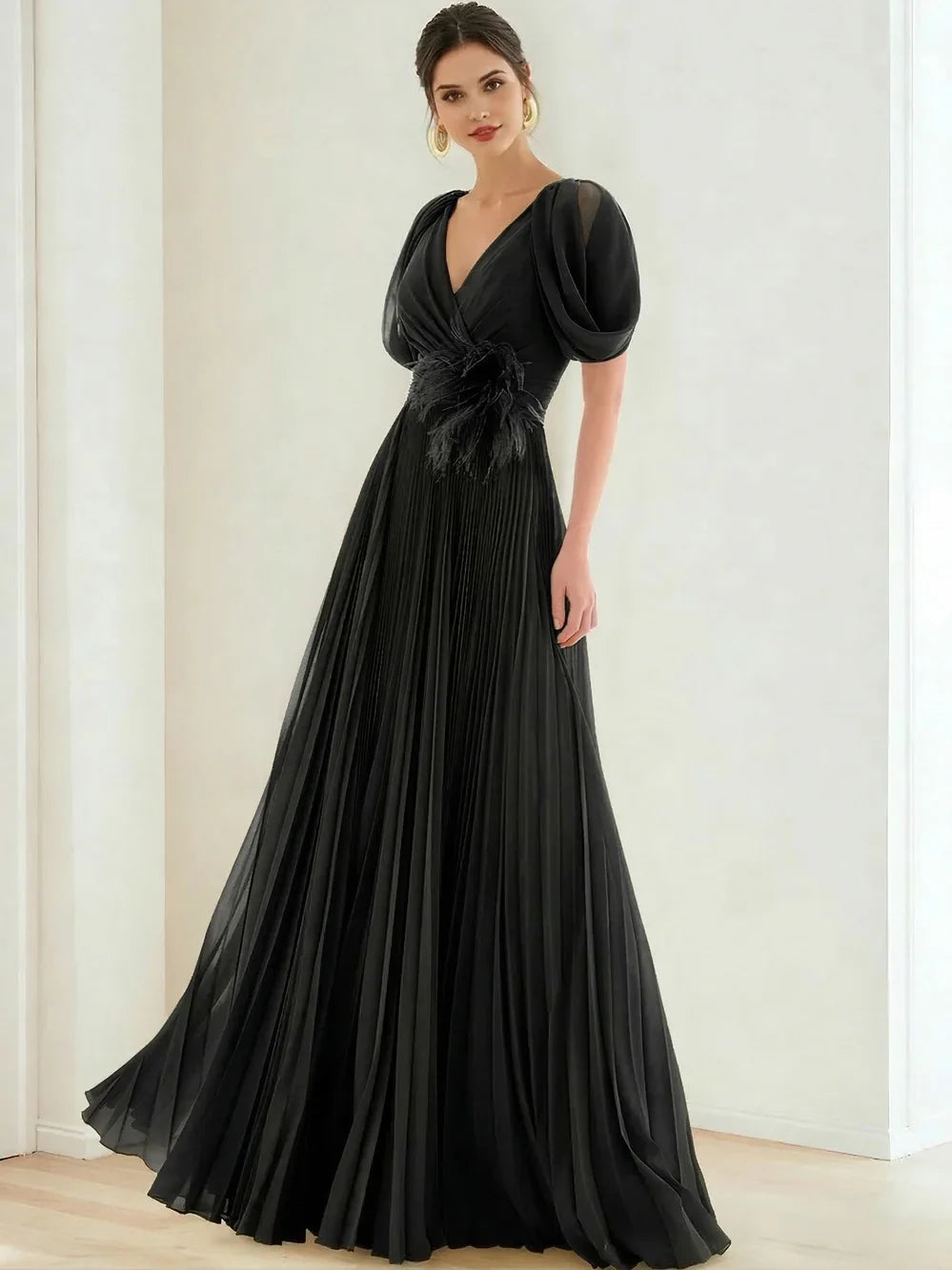 V-neck formal dress in black with puff sleeves and pleated floor-length skirt