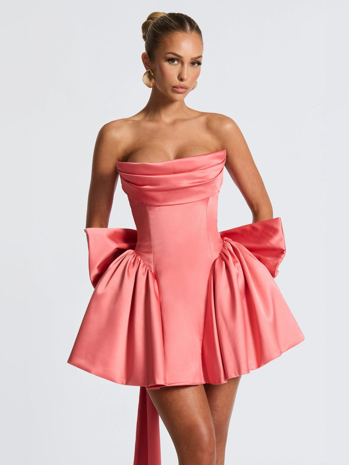 Pink strapless mini dress with ruched sweetheart bodice and layered puff skirt