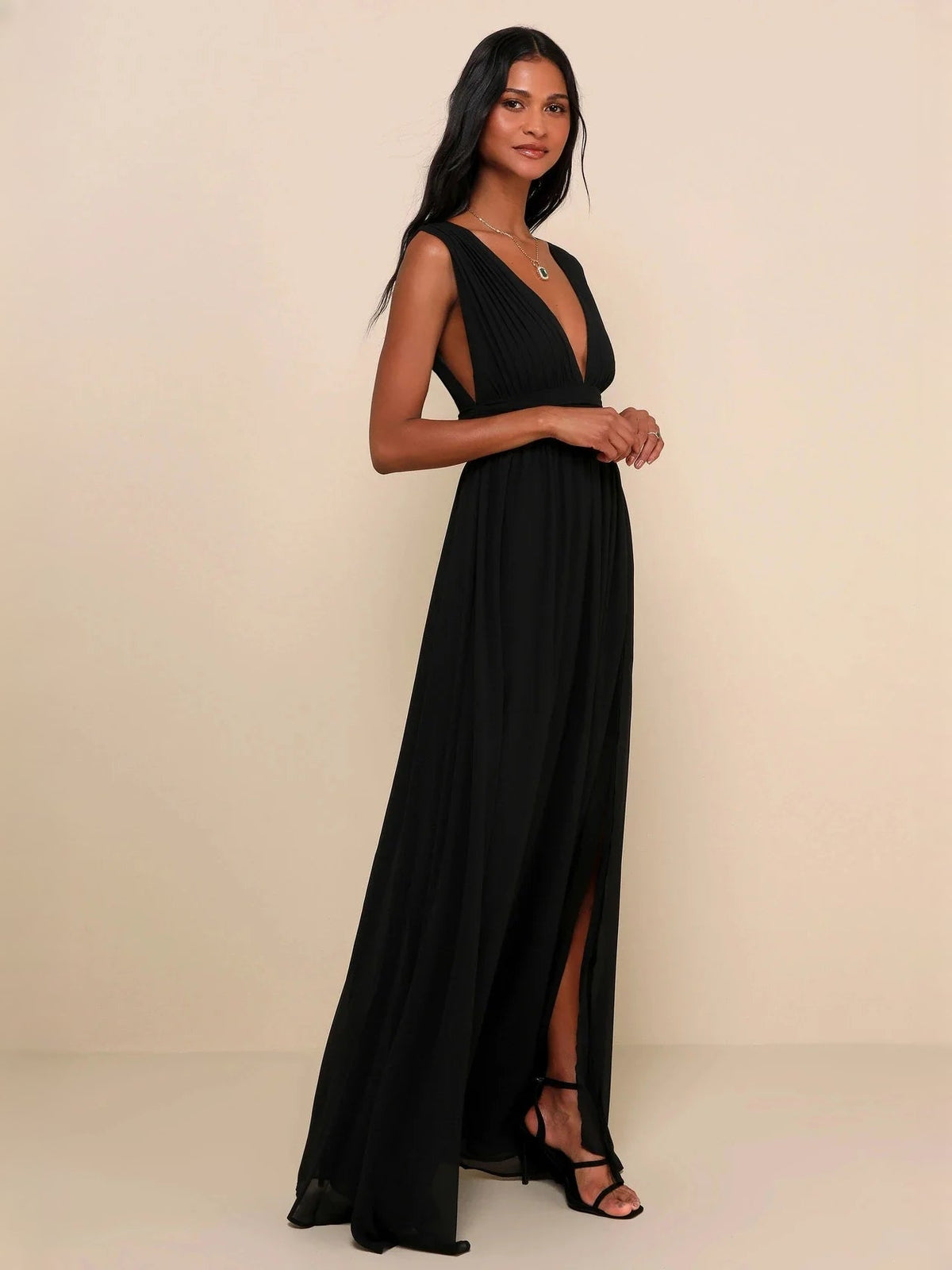 Black V-neck maxi dress with ruched waist, pleated skirt, and side slit