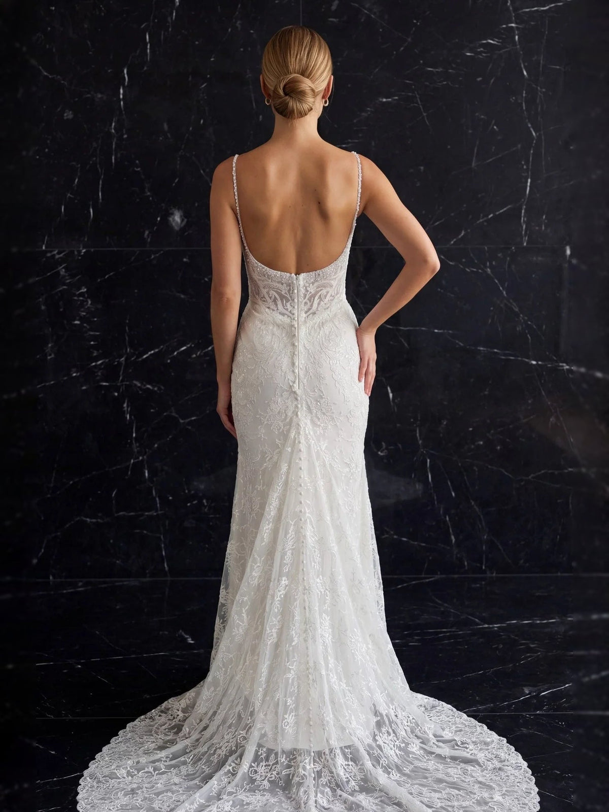 Back view: ivory beaded lace mermaid wedding dress with thin straps and long train