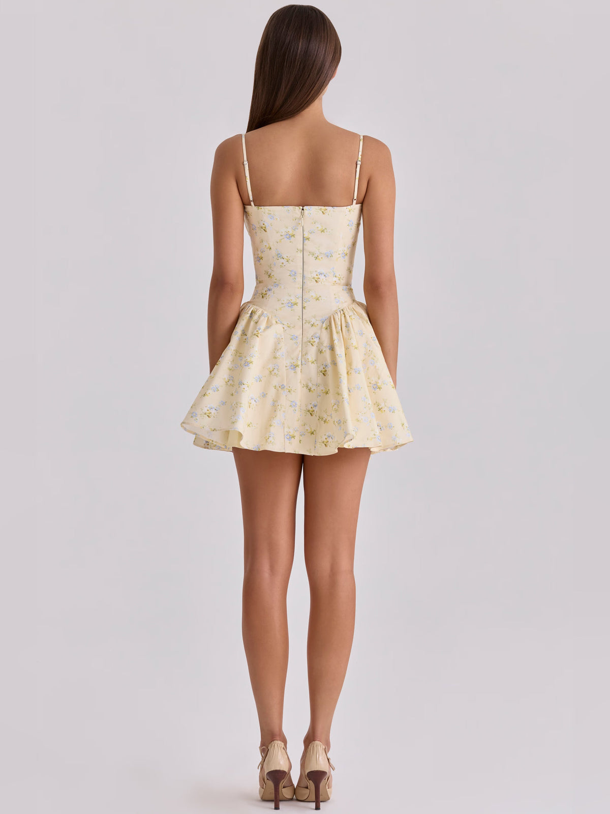 Back view of floral corset mini dress with spaghetti straps and flared skirt