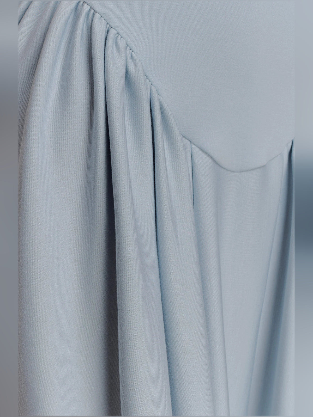 Light blue pleated midi skirt detail with gathered waist