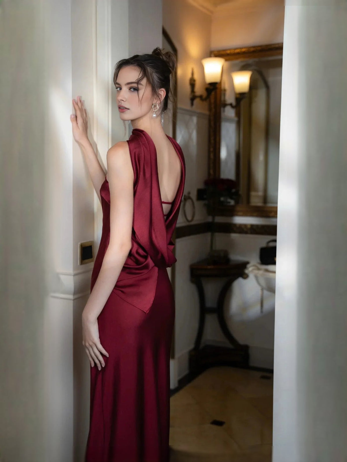 Deep red satin maxi dress with draped sleeveless bodice and open back