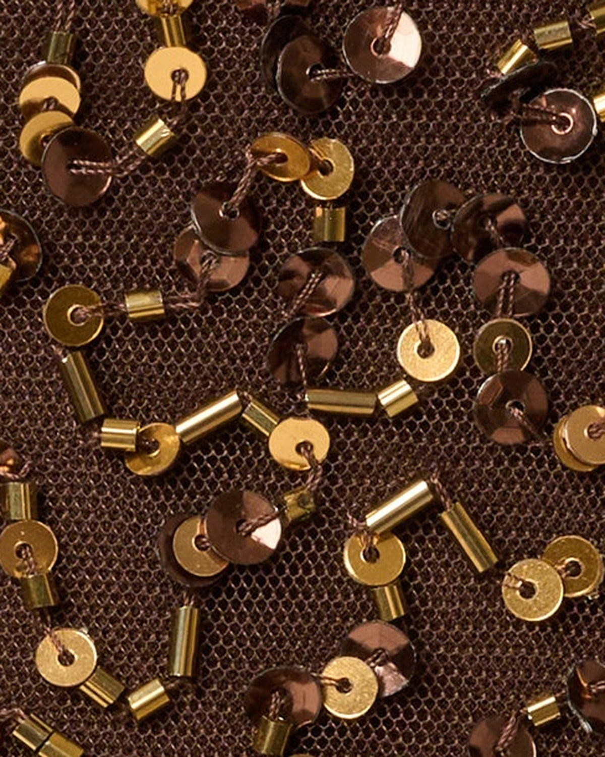 Close-up of chocolate sequin fabric with gold round embellishments