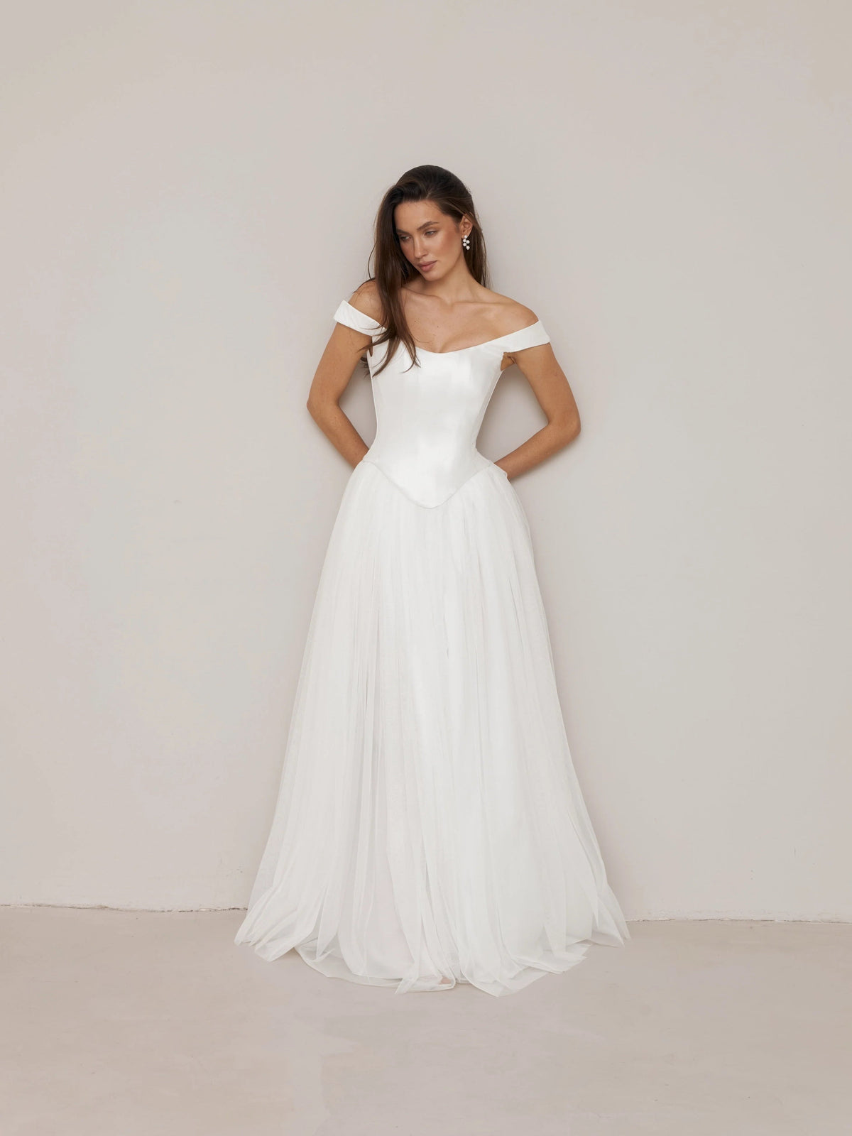 Ivory off-shoulder satin corset A-line wedding dress with floor-length layered tulle skirt