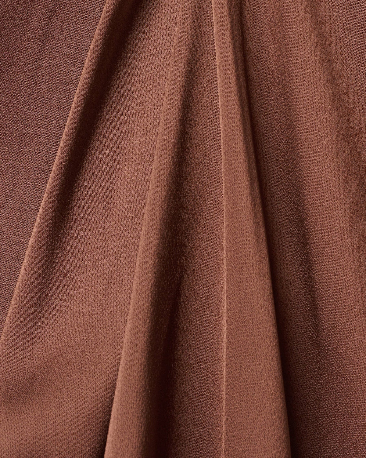 Espresso-brown woven fabric close-up with fine speckled texture