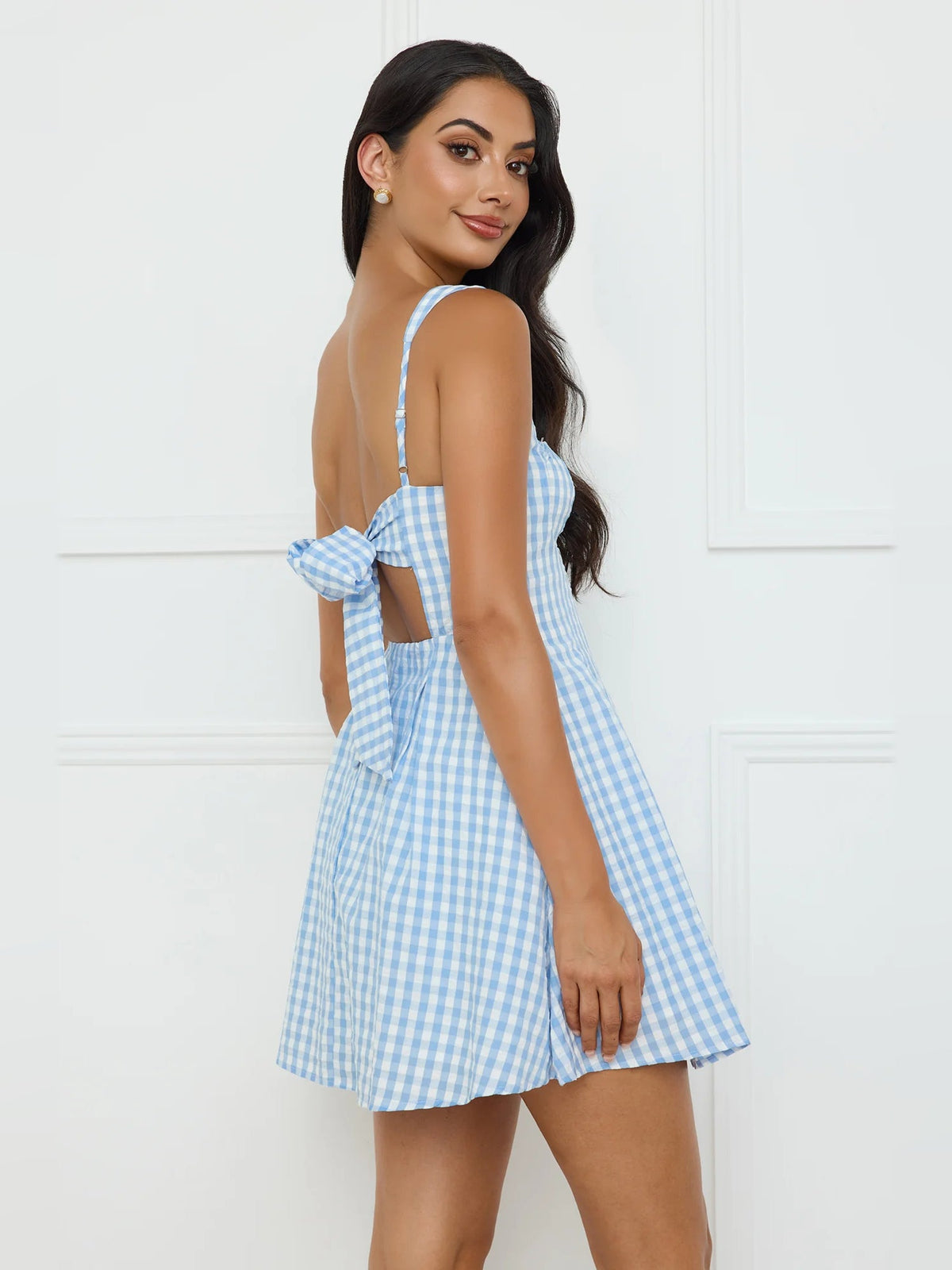 Light blue gingham mini dress with thin straps and open back with ribbon ties