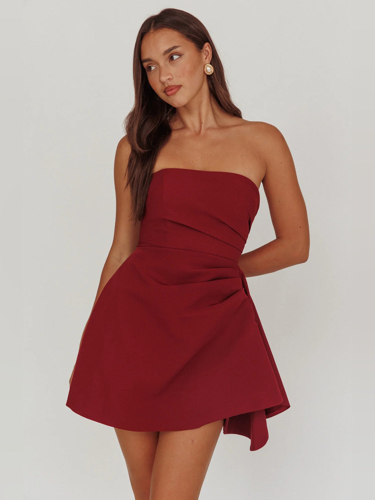 Wine strapless mini dress with ruched bodice and flared layered skirt