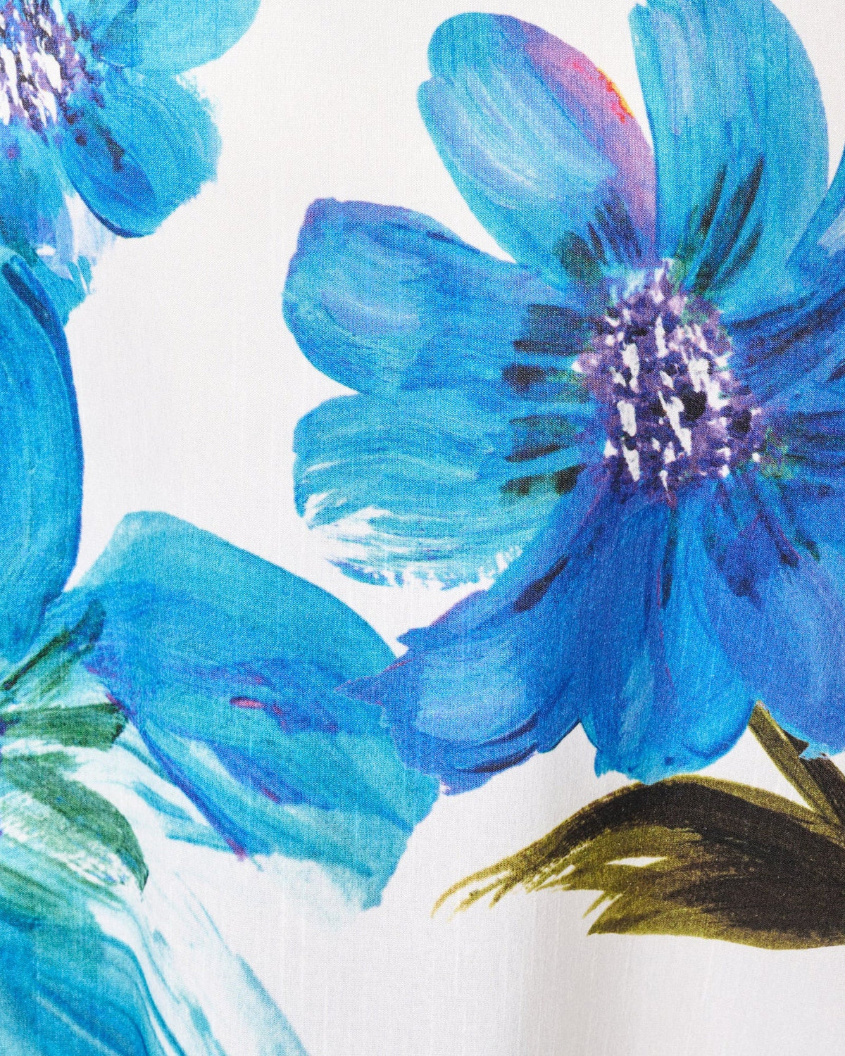 Blue floral print fabric with hand-painted look on ivory background