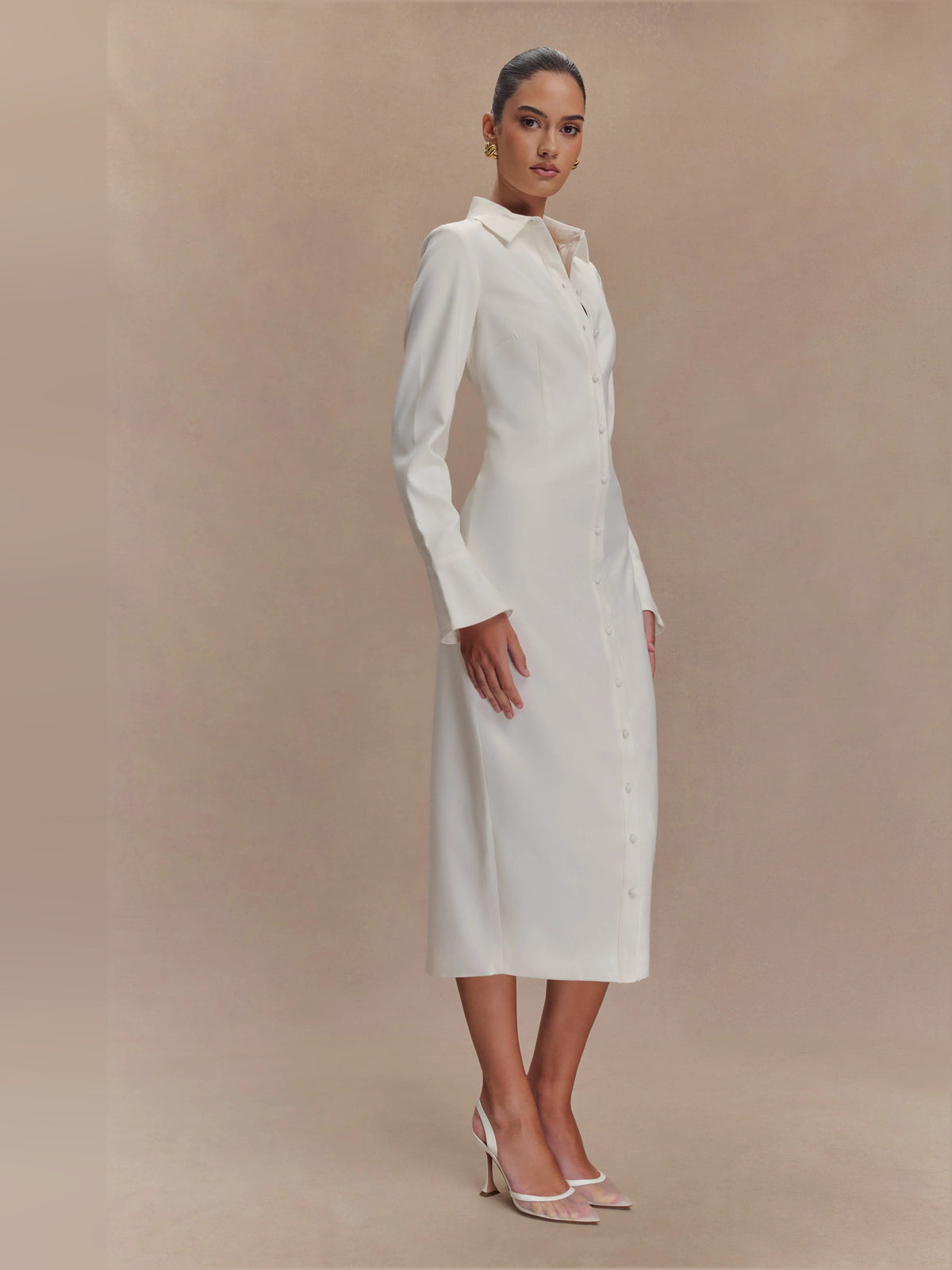 White fitted midi shirt dress three-quarter view with button front and pointed collar