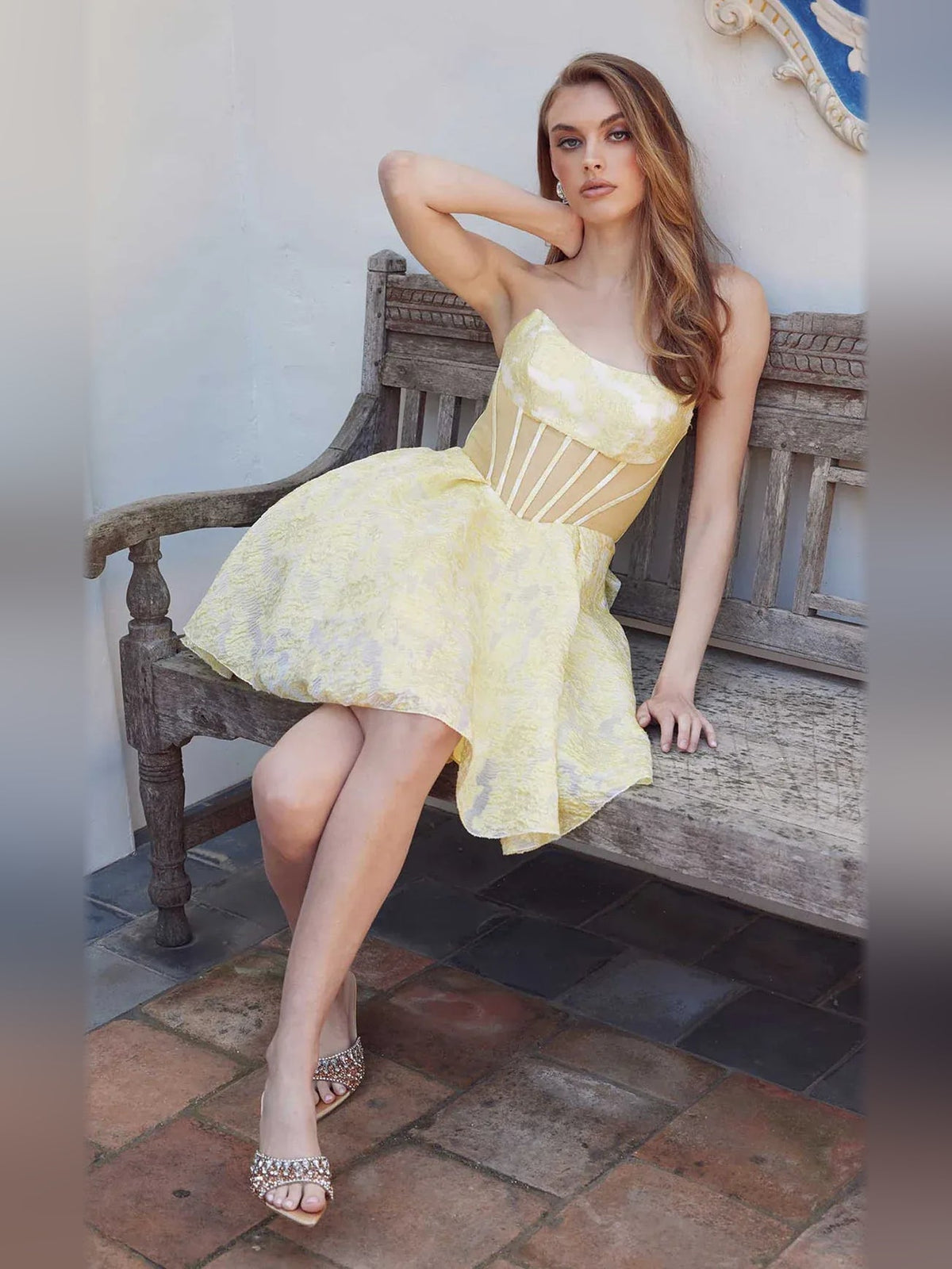 Pale lemon strapless corset A-line short dress sitting pose with ruffled bust