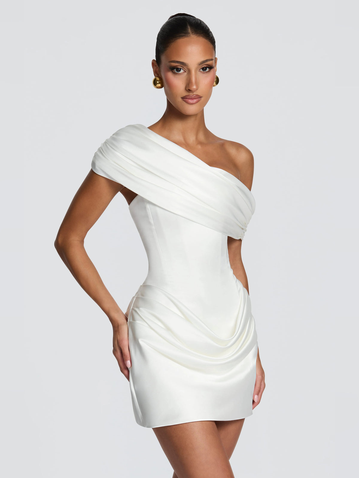 Ivory one-shoulder mini dress with draped bodice and gathered skirt