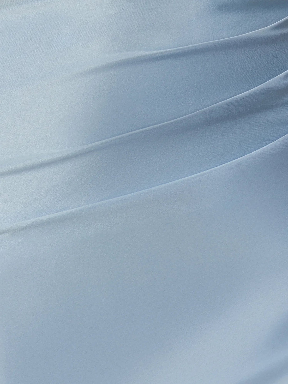 Close-up of sky blue satin fabric with smooth sheen