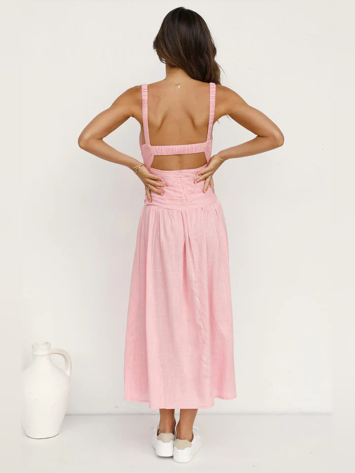 Back view of blush pink backless midi formal dress with crisscross open back and slit