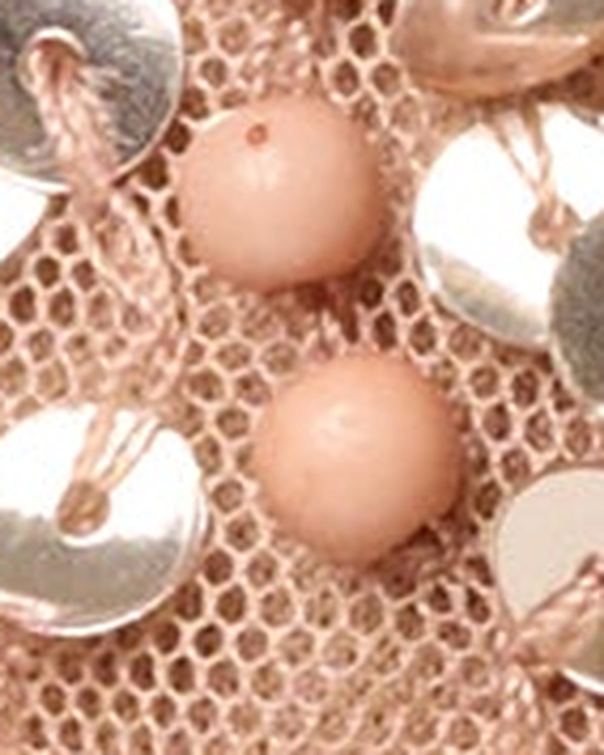 Rose gold sequin fabric close-up with metallic dot pattern