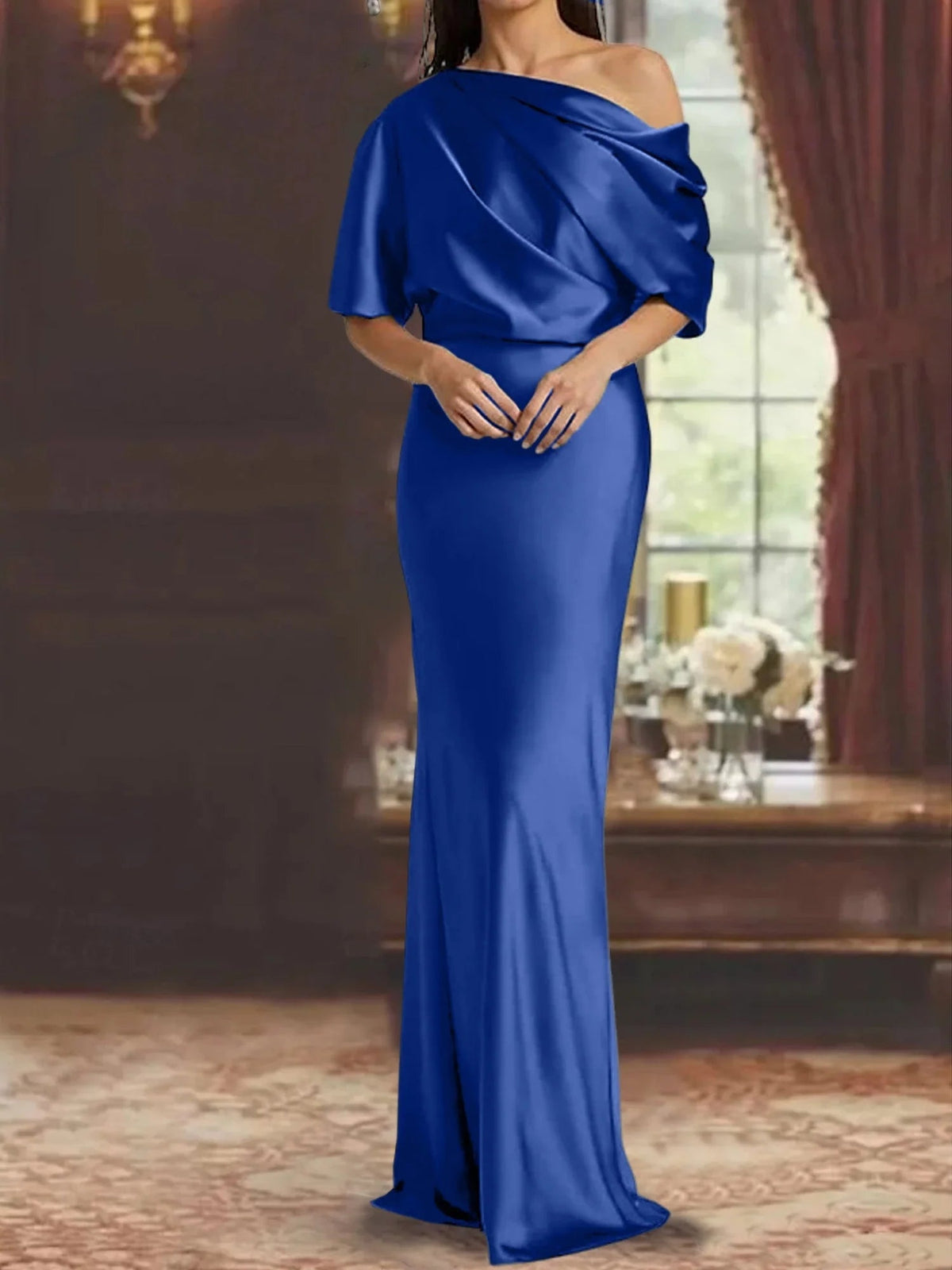 Dark blue one-shoulder draped satin mermaid gown with voluminous shoulder ruffle