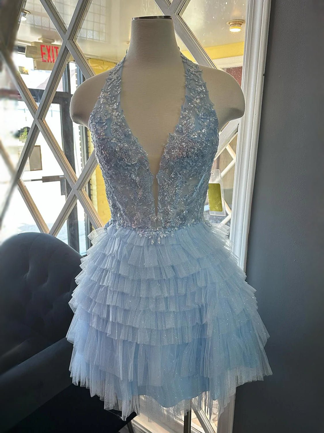 Light blue ruffled V-neck mini A-line prom dress with tiered tulle skirt and sleeveless bodice.