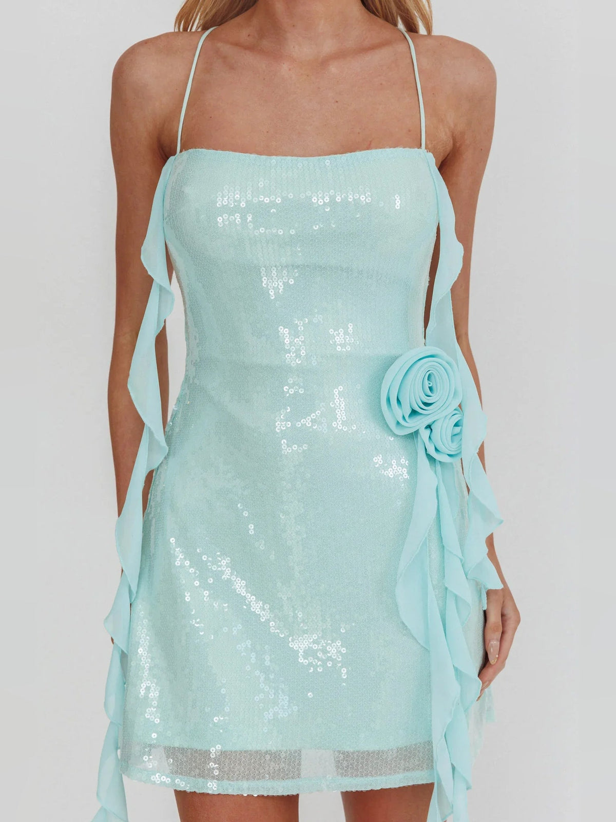 Ice blue sequined mini dress with rosette detail at bust and flowing side tassels