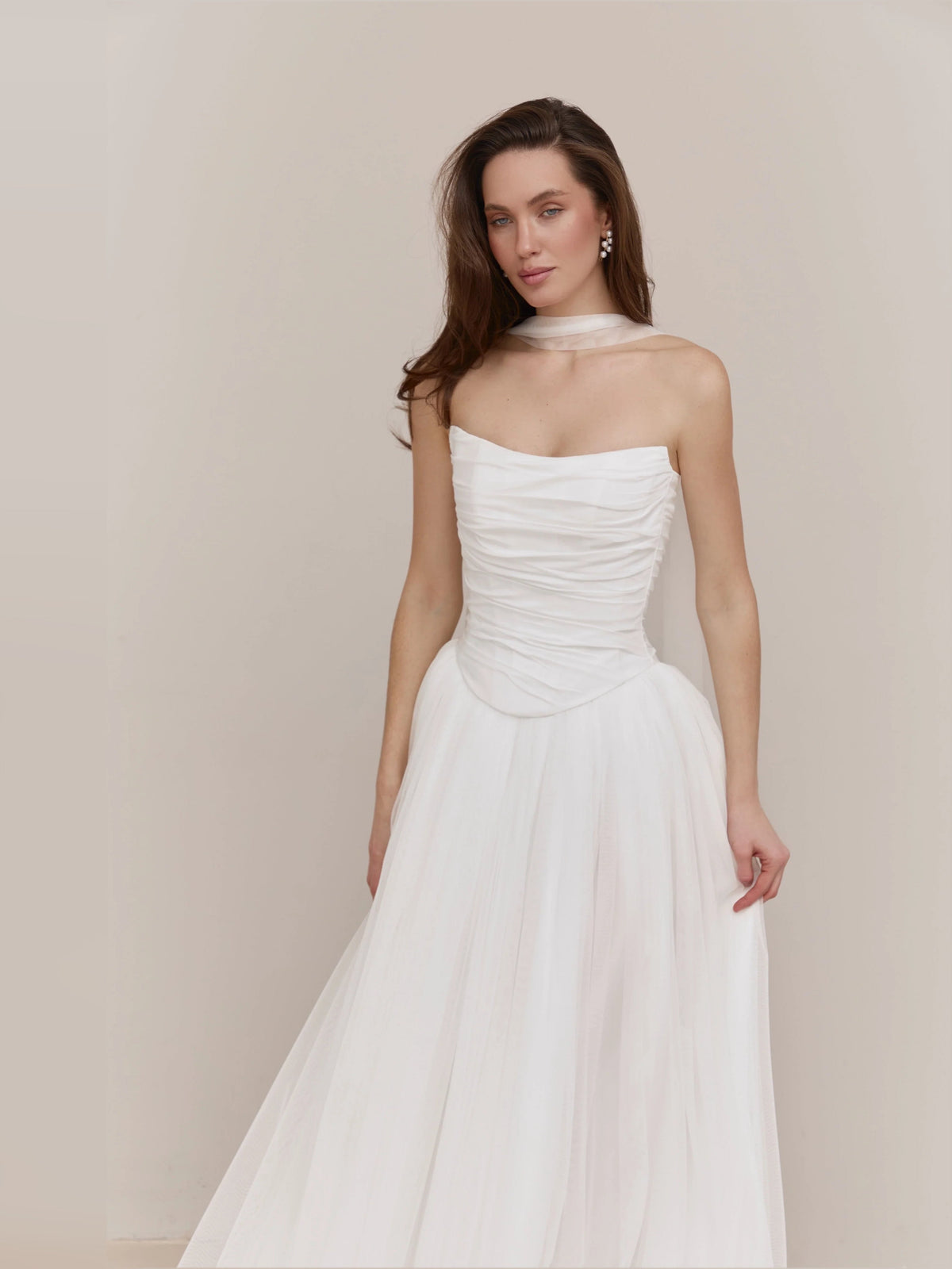Ivory strapless A-line wedding dress with ruched bodice and pleated skirt, side view