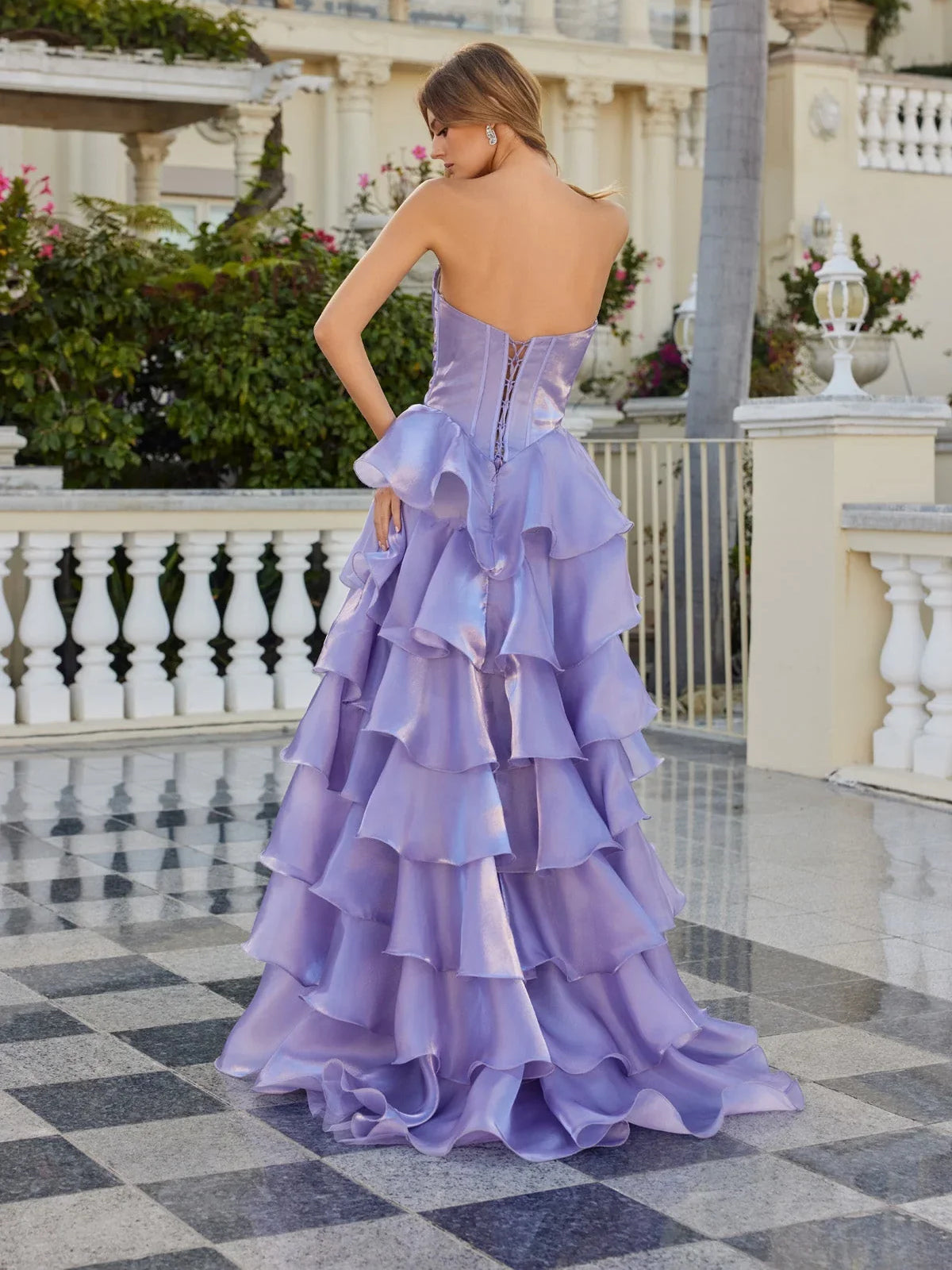 Lilac corset prom gown with open back and tiered ruffle skirt with thigh slit