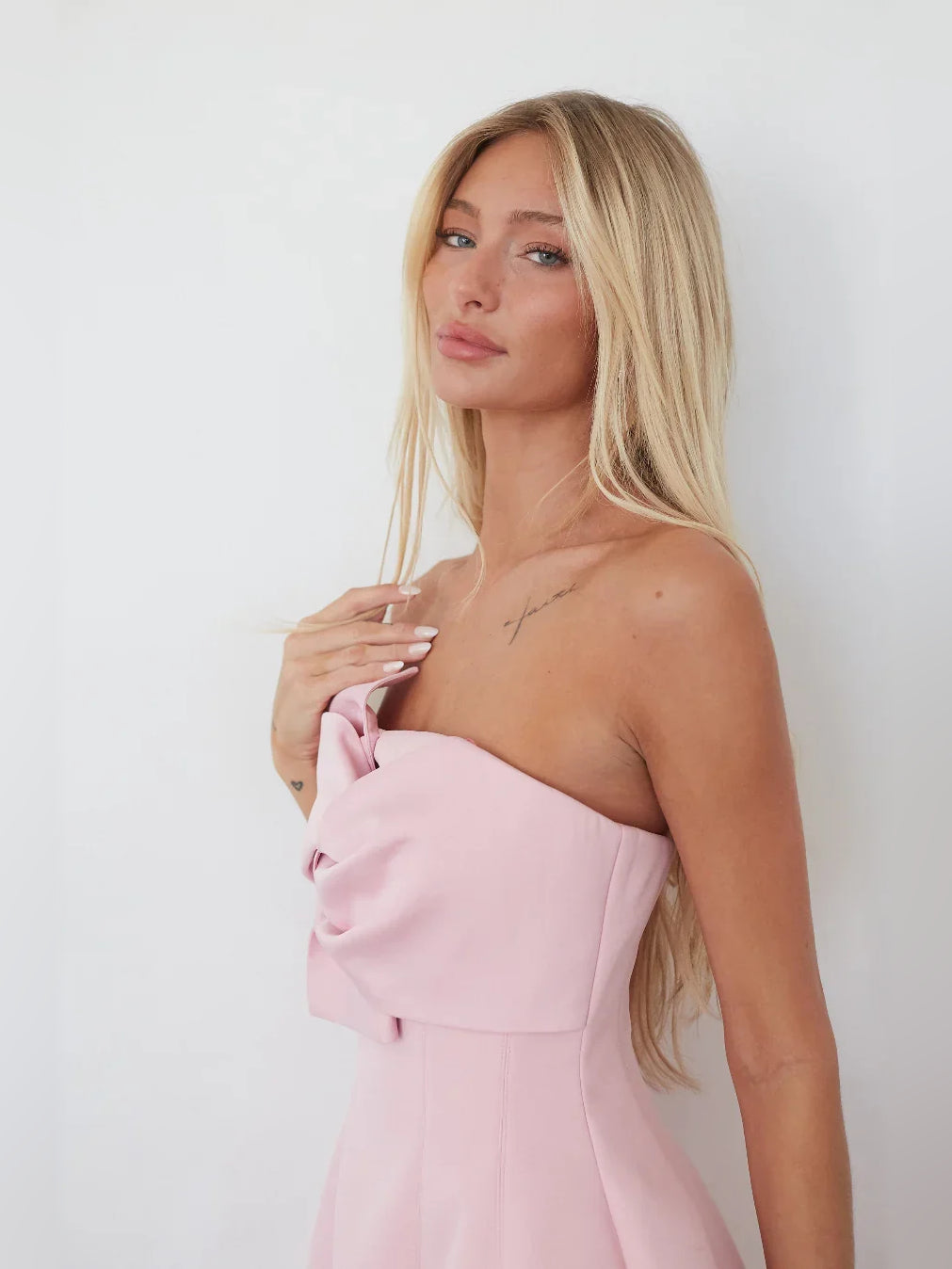 Light pink strapless A-line mini crepe dress with large bow at bust