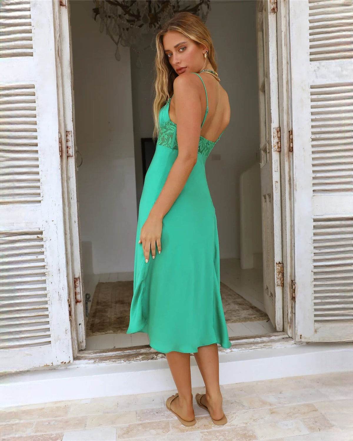 Mint green satin midi bridesmaid dress from side view, sleeveless with ruched bodice
