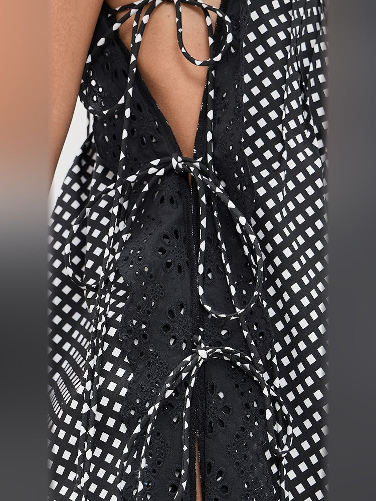 Black open-back dress detail with lace-up tie and eyelet-like back panels