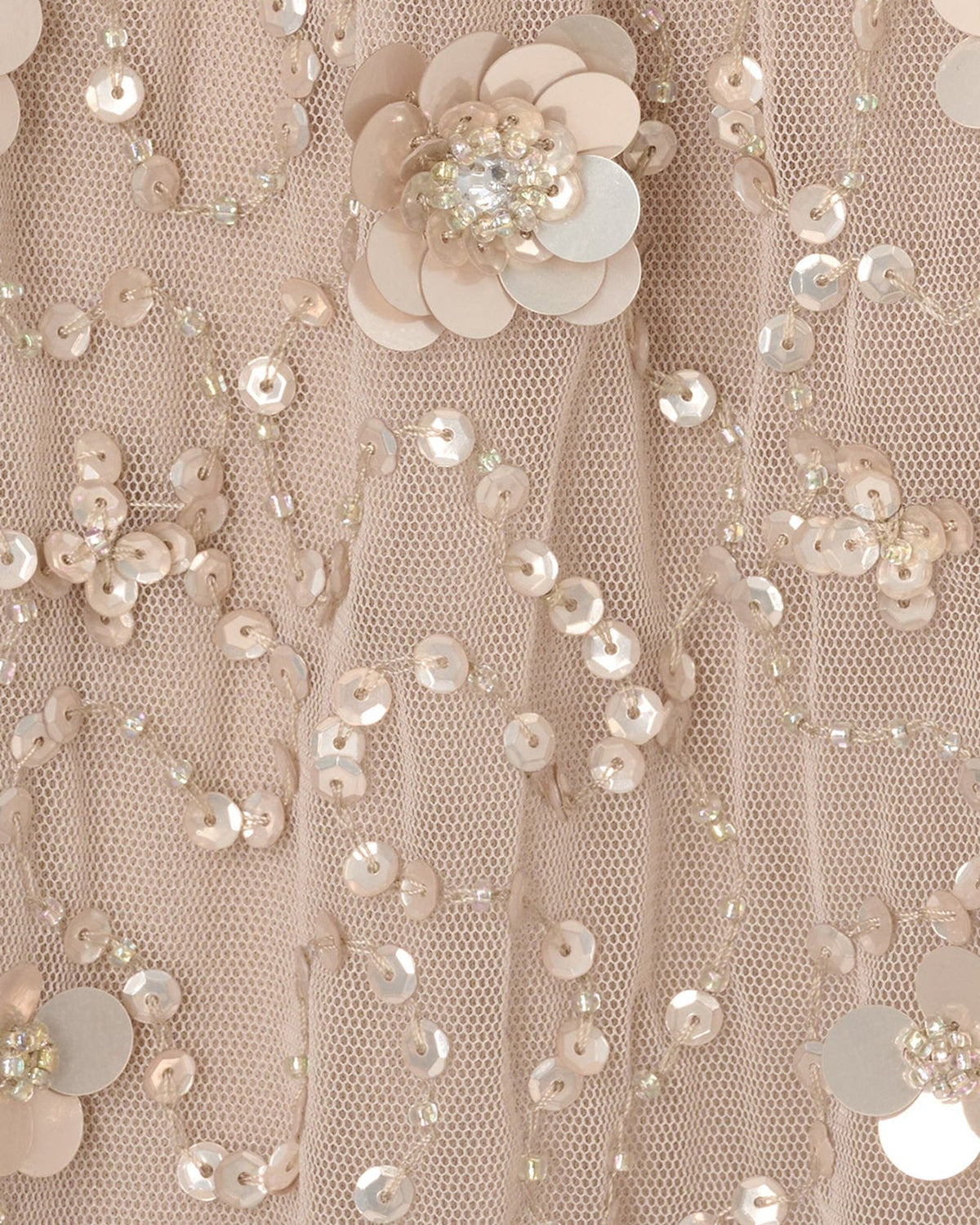 Silver mesh fabric with scattered floral applique and sparkling bead sequins close-up
